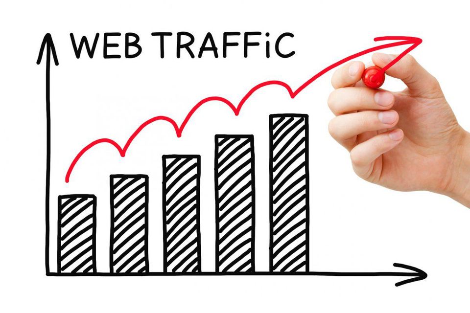 Picture of bar graph and internet marketer drawing a line showing web traffic going up.